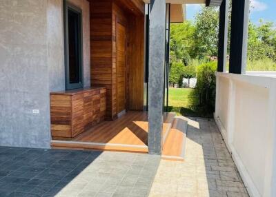 Modern outdoor entryway with wooden and concrete elements