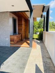 Modern outdoor entryway with wooden and concrete elements