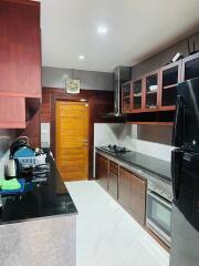 Modern kitchen with dark wood cabinets and appliances