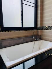 Bathroom with bathtub and window