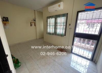 Living room with tiled floor and large window