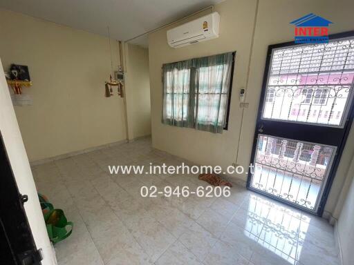 Living room with tiled floor and large window