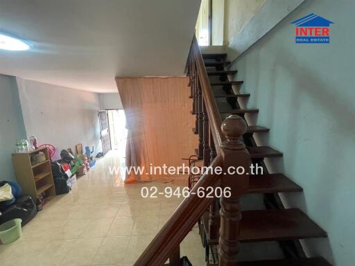Living area with staircase leading to upper floor