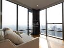 Spacious living room with large windows and city view