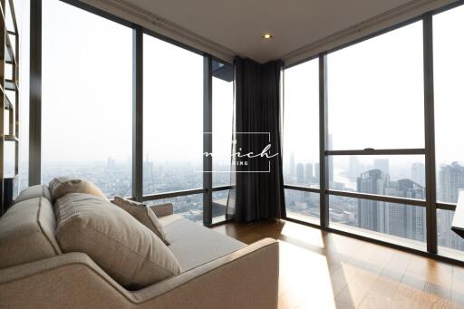 Spacious living room with large windows and city view