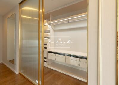 Walk-in closet with built-in drawers and shelving