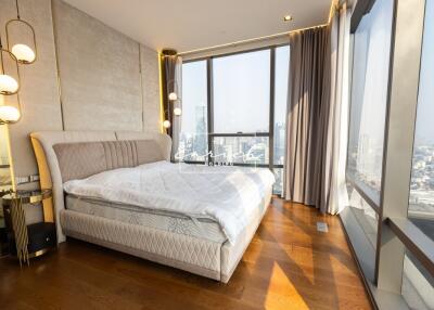 Modern bedroom with floor-to-ceiling windows and city view