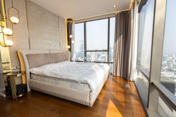 Modern bedroom with floor-to-ceiling windows and city view