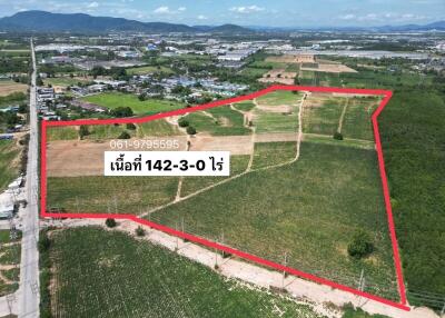 Aerial view of a large plot of land with boundaries marked in red.