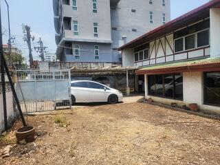 Exterior view with driveway, garage, and parking space