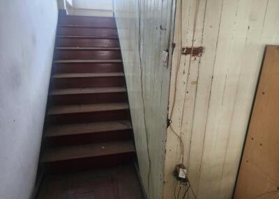 A wooden stairway with a handrail and wall paneling
