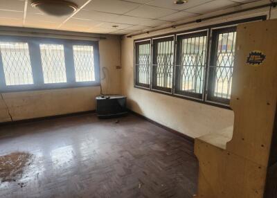 Empty room with barred windows and wooden floors