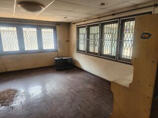 Empty room with barred windows and wooden floors