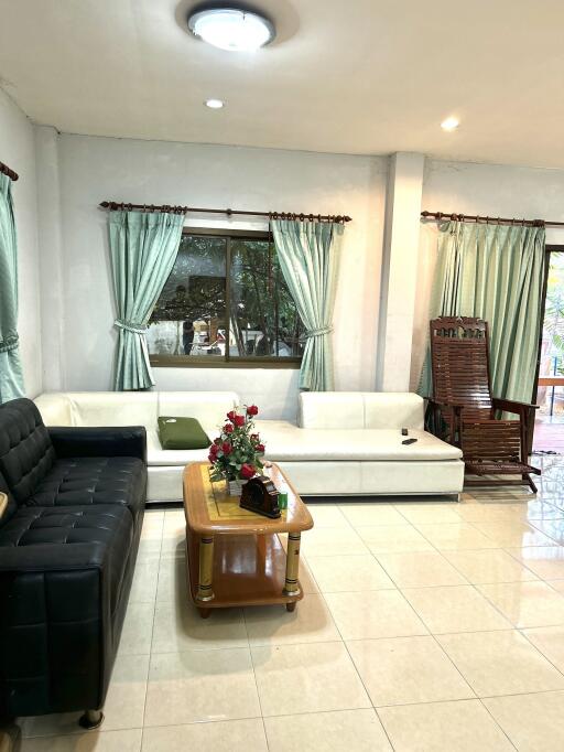 Living room with sofas, coffee table, and rocking chair