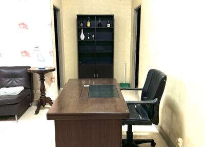 Office with desk and shelving unit