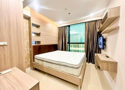 Modern bedroom with wooden furniture and large window