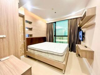 Modern bedroom with wooden furniture and large window