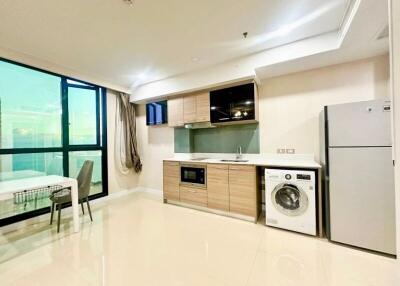 Modern kitchen with built-in appliances and adjacent dining area