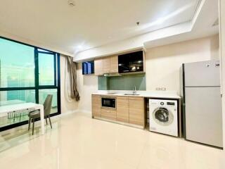 Modern kitchen with built-in appliances and adjacent dining area