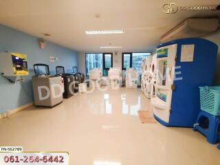 Spacious and clean laundry room with multiple washing machines and dryers