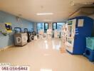 Spacious and clean laundry room with multiple washing machines and dryers