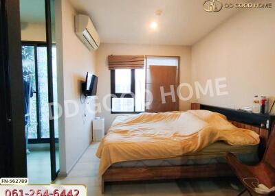 Spacious bedroom with a bed, television, air conditioning, and a window.