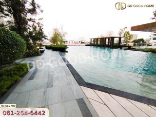 Outdoor swimming pool with surrounding seating and greenery