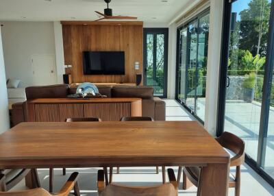 Spacious living room with large windows and modern furniture