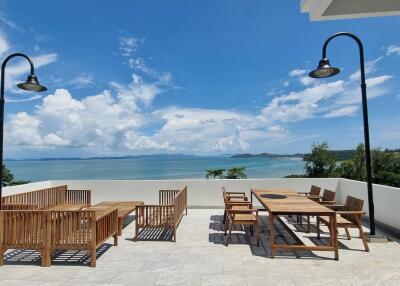 Outdoor terrace with wooden furniture and ocean view