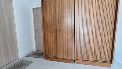 Bedroom with large wooden wardrobe and door