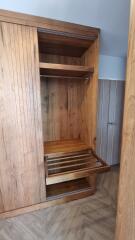 wooden built-in wardrobe with open shelves and drawers