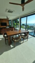 Dining area with wooden furniture and pool view