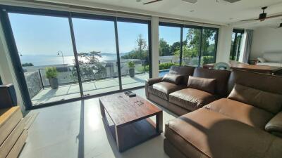 Spacious living room with large windows and a sea view