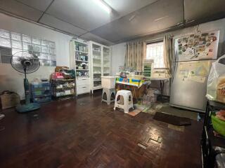 Spacious kitchen with various furniture and appliances