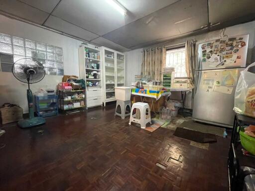 Spacious kitchen with various furniture and appliances