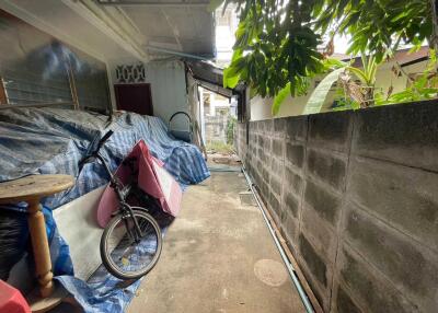 Outdoor alleyway with bike and covered items