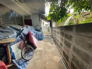 Outdoor alleyway with bike and covered items