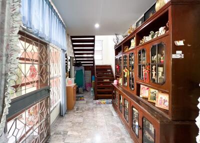 Living space with staircase and display cabinets