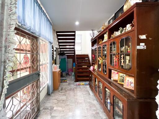 Living space with staircase and display cabinets