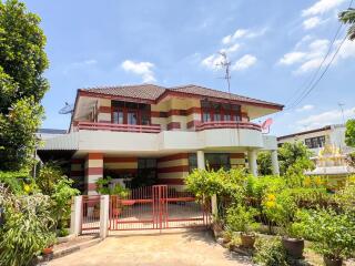 Two-story house with a red and white striped exterior