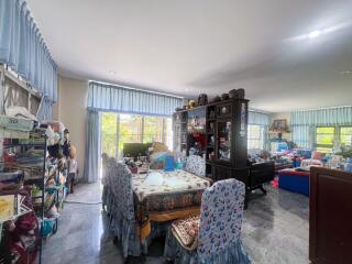 Spacious living room with dining area and large windows