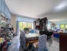 Spacious living room with dining area and large windows