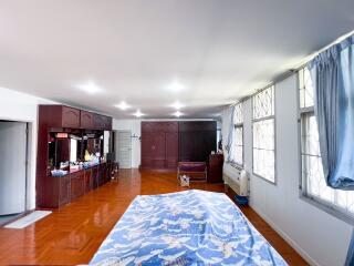 Spacious bedroom with windows and built-in cabinets