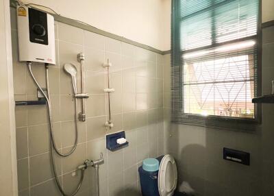Bathroom with water heater and blue toilet
