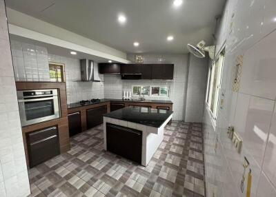 Modern kitchen with wooden cabinets and tiled flooring