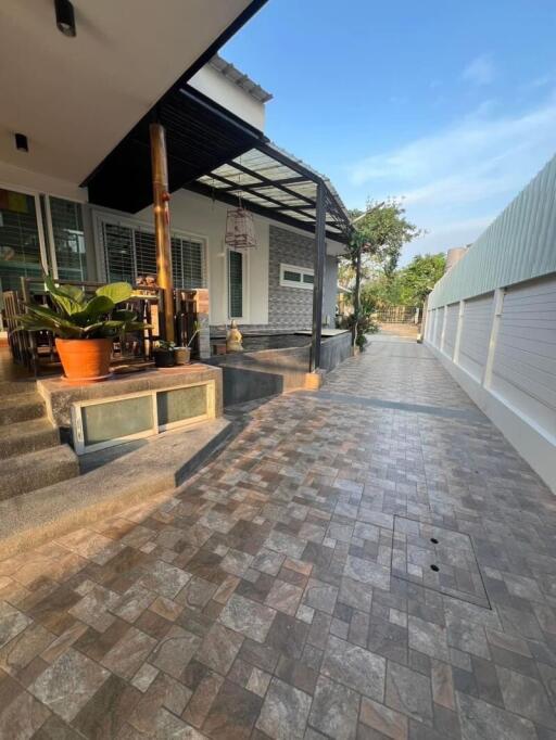 Exterior view of a modern house with tiled pathway