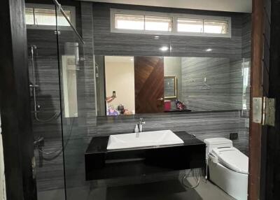 Modern bathroom with glass shower and vanity mirror