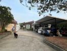 Driveway leading to multiple carports with well-kept surroundings