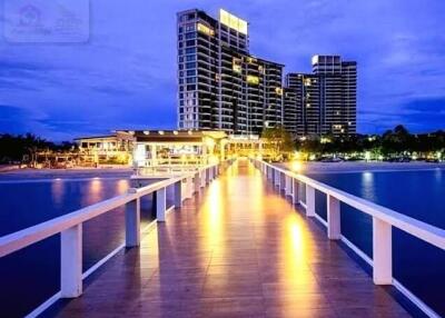 Waterfront high-rise buildings with a lit pier