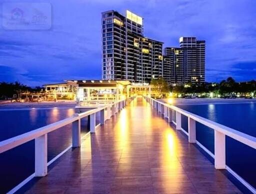 Waterfront high-rise buildings with a lit pier
